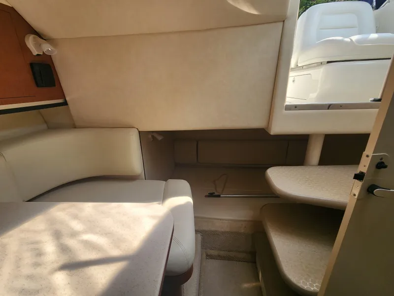 Slide: The Image of Interior cabin of a 2004 Sea Ray 290 Amberjack boat with seating and steps. - 17