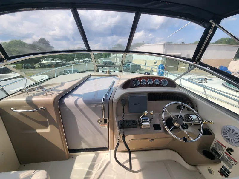 Slide: The Image of 2004 Sea Ray 290 Amberjack helm with steering wheel, controls, and gauges. - 20
