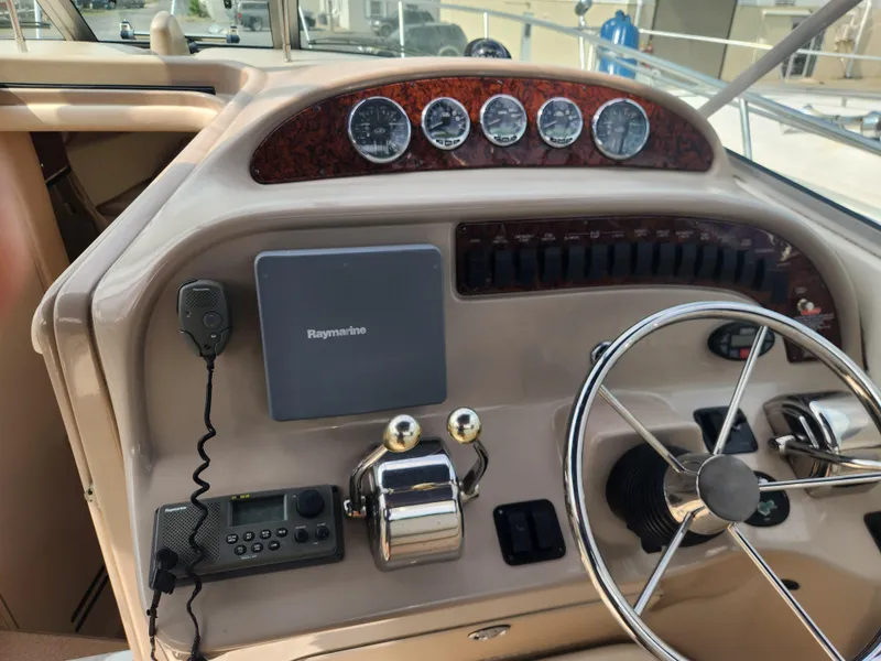 Slide: The Image of 2004 Sea Ray 290 Amberjack boat dashboard with steering wheel and control panel. - 28