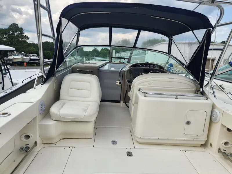 Slide: The Image of 2004 Sea Ray 290 Amberjack boat interior with seating and helm station. - 30