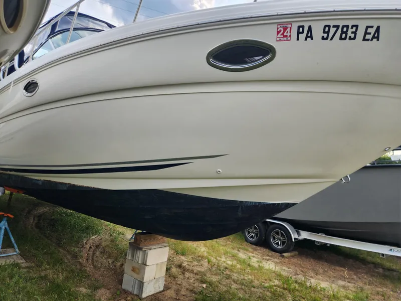 Slide: The Image of 2004 Sea Ray 290 Amberjack boat on blocks, side view, registration PA 9783 EA. - 32
