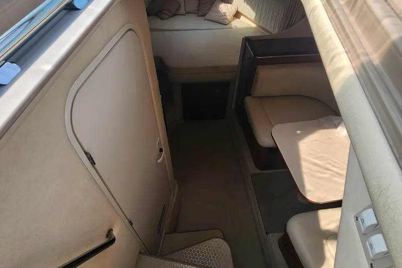 Slide: The Image of 2004 Sea Ray 290 Amberjack cabin interior with seating and table. - 44