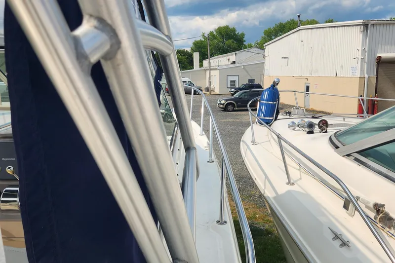 Slide: The Image of 2004 Sea Ray 290 Amberjack boats docked near a marina warehouse. - 46