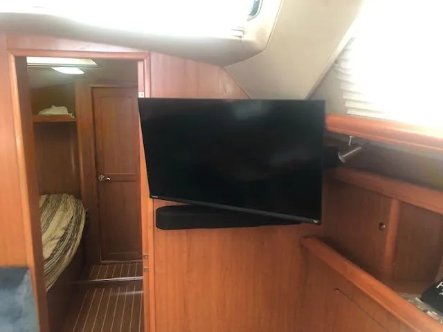 Slide: The Image of Interior of 2008 Hunter 41 Deck Salon with mounted TV and cozy cabin. - 11
