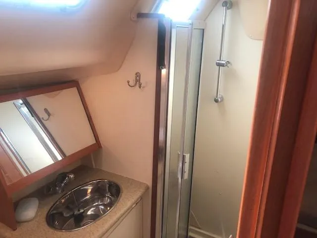 Slide: The Image of 2008 Hunter 41 Deck Salon bathroom with sink, mirror, and shower. - 17