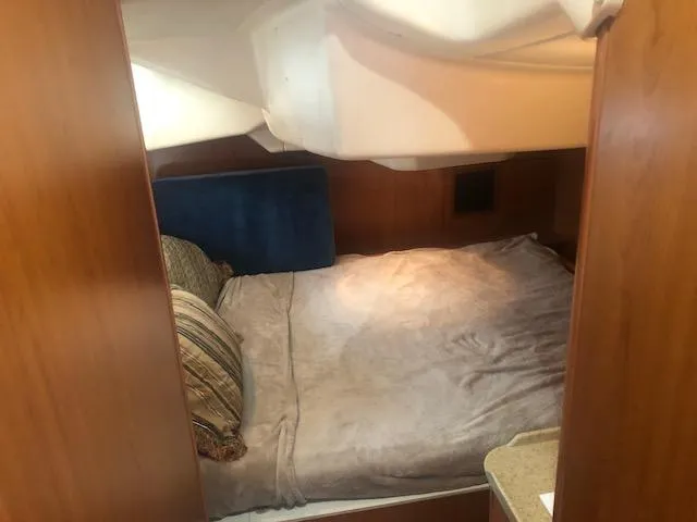 Slide: The Image of Cozy bedroom in 2008 Hunter 41 Deck Salon sailboat with wooden paneling and soft bedding. - 5