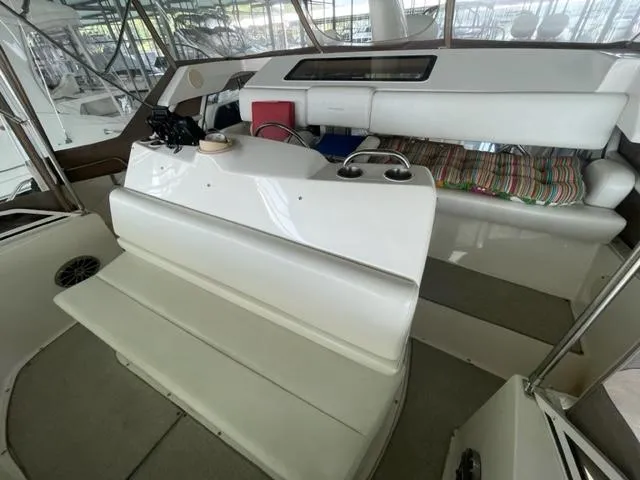 Slide: The Image of 1999 Silverton 392 Motor Yacht interior with seating and helm area. - 12