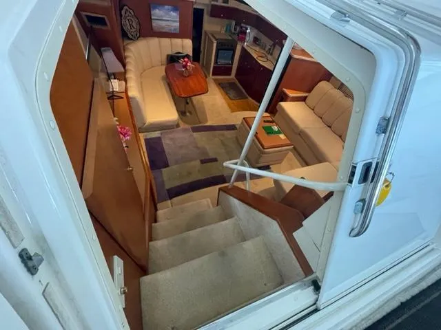 Slide: The Image of Interior view of 1999 Silverton 392 Motor Yacht, featuring cozy seating and elegant decor. - 21