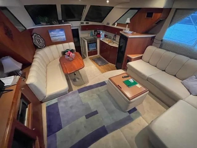 Slide: The Image of Interior of 1999 Silverton 392 Motor Yacht with cozy seating and modern kitchen area. - 22