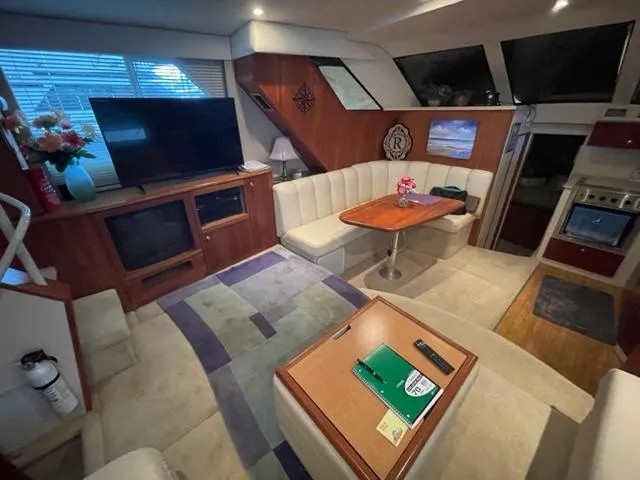 Slide: The Image of Interior of 1999 Silverton 392 Motor Yacht with cozy seating and modern amenities. - 23