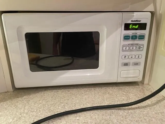 Slide: The Image of GoldStar microwave on countertop, displaying "End" on screen. - 27
