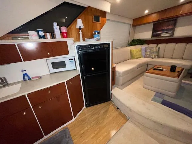 Slide: The Image of Interior of 1999 Silverton 392 Motor Yacht with kitchen and cozy seating area. - 30