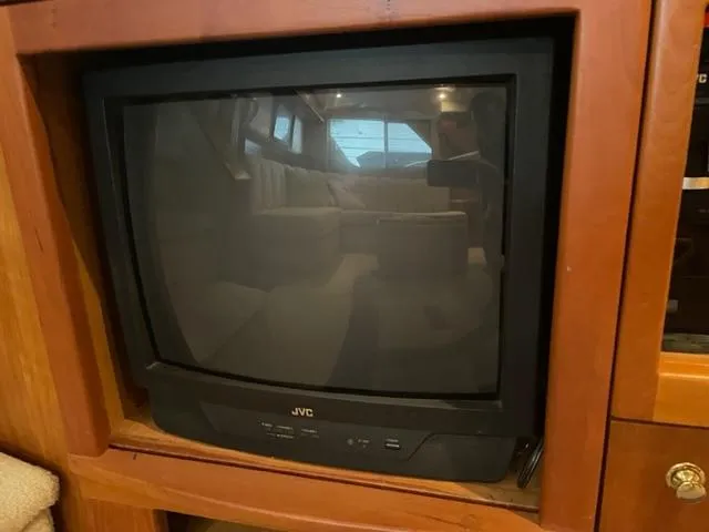 Slide: The Image of JVC television inside a 1999 Silverton 392 Motor Yacht's wooden cabinet. - 35