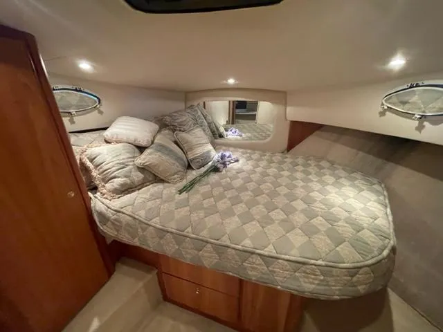 Slide: The Image of Cozy bedroom in 1999 Silverton 392 Motor Yacht with quilted bedding and ambient lighting. - 36