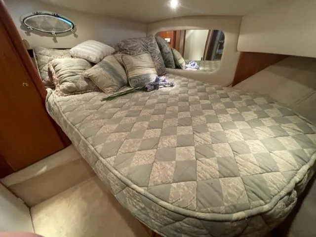 Slide: The Image of Cozy bedroom in 1999 Silverton 392 Motor Yacht with quilted bedding and decorative pillows. - 37