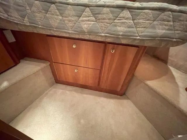 Slide: The Image of 1999 Silverton 392 Motor Yacht interior with wooden cabinets and carpeted flooring. - 38