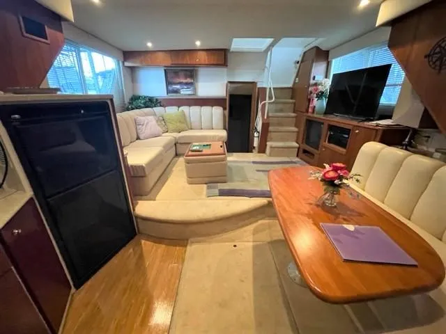 Slide: The Image of Interior of 1999 Silverton 392 Motor Yacht with cozy seating and dining area. - 41