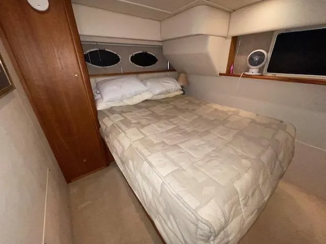 Slide: The Image of Cozy bedroom in 1999 Silverton 392 Motor Yacht with double bed and porthole windows. - 43