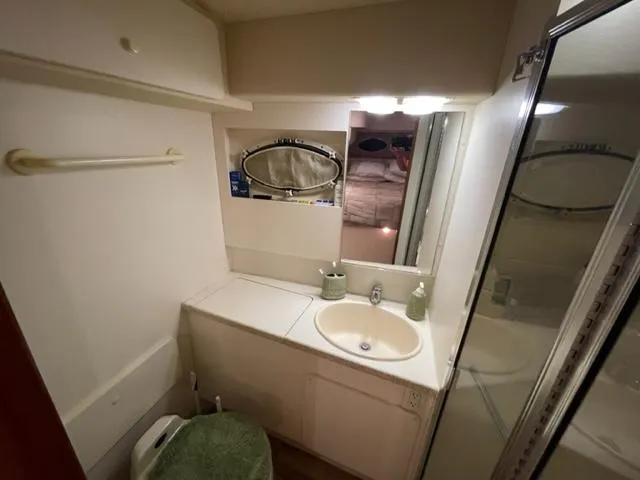 Slide: The Image of 1999 Silverton 392 Motor Yacht bathroom with sink, mirror, and shower. - 47