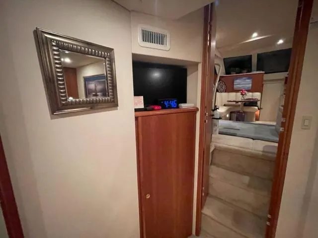 Slide: The Image of Interior of 1999 Silverton 392 Motor Yacht with wooden cabinetry and framed artwork. - 48