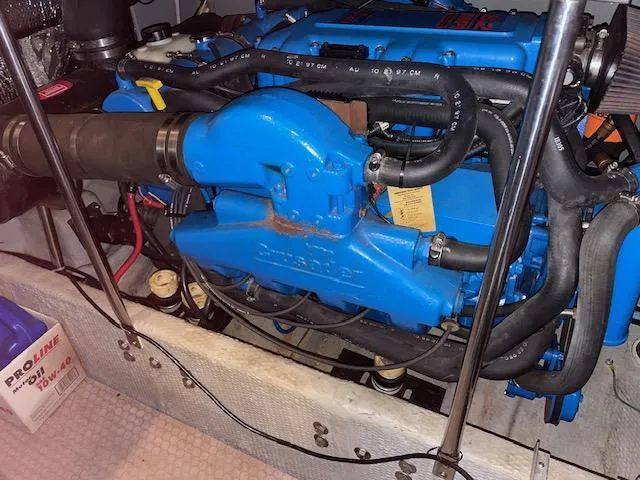 Slide: The Image of Engine of a 1999 Silverton 392 Motor Yacht, featuring blue components and black hoses. - 49