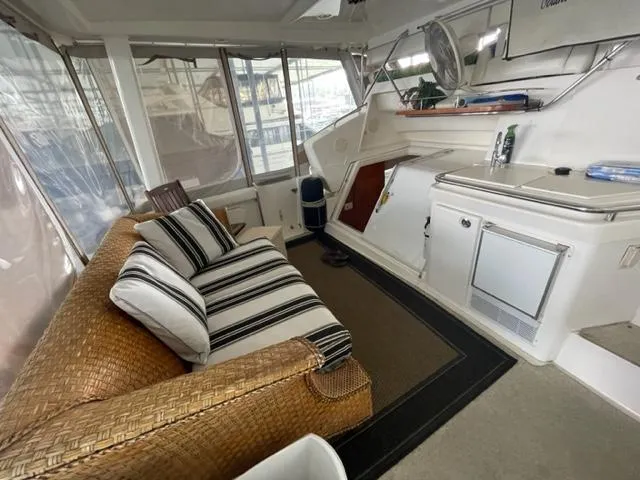 Slide: The Image of Interior of 1999 Silverton 392 Motor Yacht with wicker sofa and kitchenette. - 7