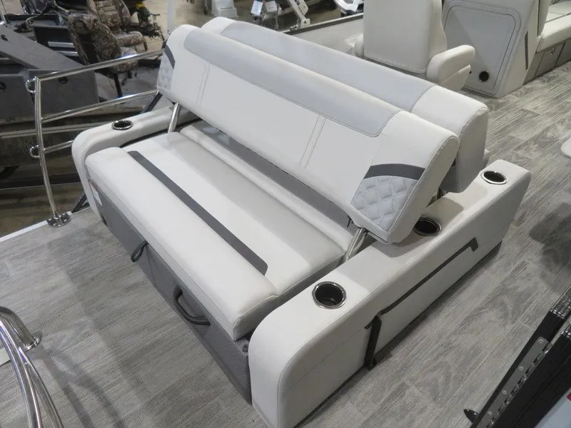 Slide: The Image of 2024 Crest Classic DLX 240 SLSC boat interior seating with cup holders. - 11
