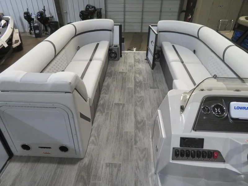 Slide: The Image of 2024 Crest Classic DLX 240 SLSC pontoon boat interior with spacious seating and modern dashboard. - 13