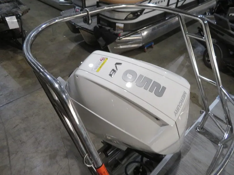 Slide: The Image of 2024 Crest Classic DLX 240 SLSC boat with a powerful outboard motor. - 14