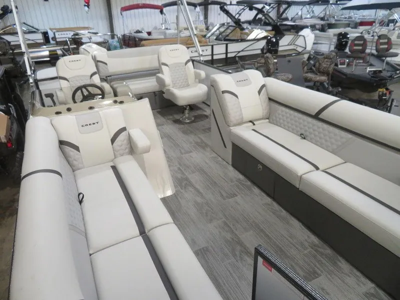 Slide: The Image of 2024 Crest Classic DLX 240 SLSC pontoon boat interior with luxurious seating. - 16