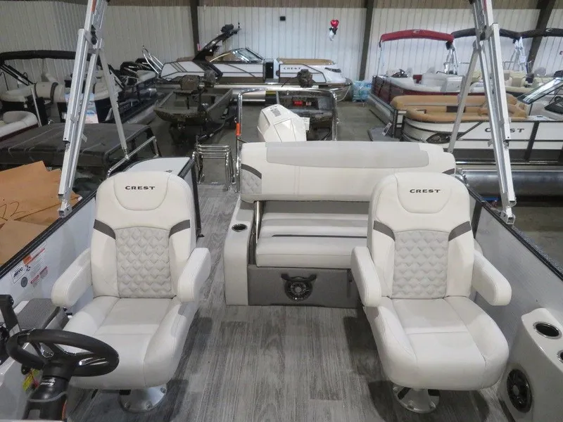 Slide: The Image of 2024 Crest Classic DLX 240 SLSC pontoon boat interior with white seating. - 3