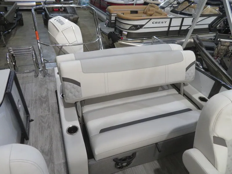 Slide: The Image of 2024 Crest Classic DLX 240 SLSC pontoon boat interior with plush seating. - 9