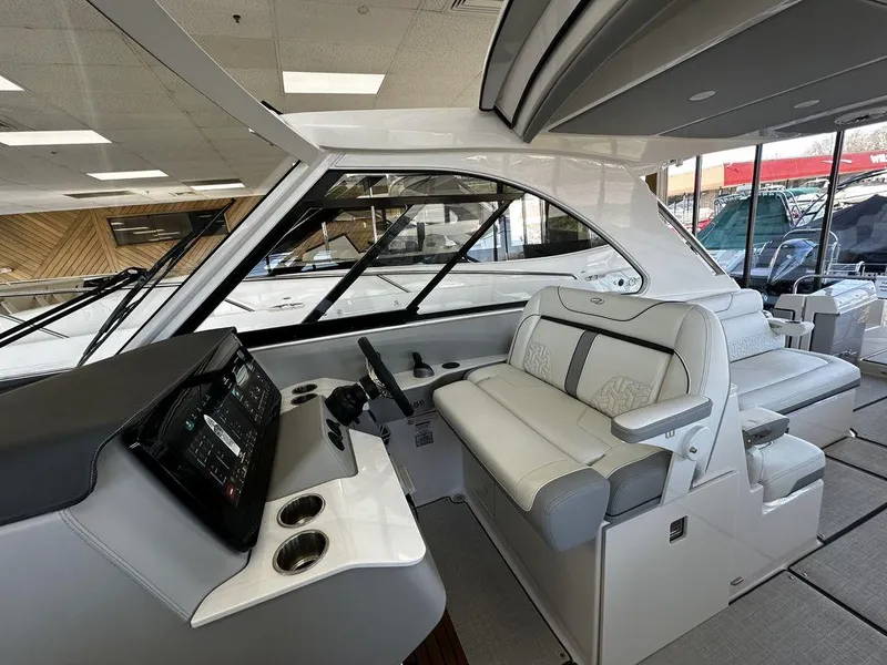 Slide: The Image of Interior of 2024 Regal LS36 boat with modern helm and luxurious seating. - 11