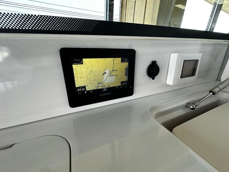Slide: The Image of 2024 Regal LS36 boat dashboard with Garmin GPS navigation system. - 12