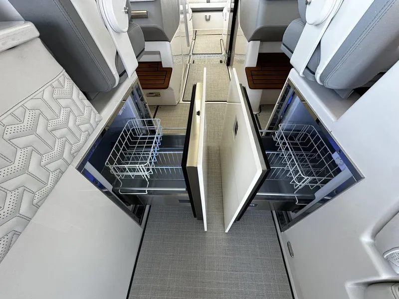 Slide: The Image of 2024 Regal LS36 boat interior with open storage compartments and modern seating. - 25