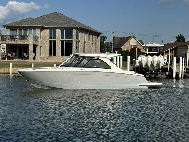 Slide: The Image of 2024 Regal LS36 boat docked near waterfront homes. - 3