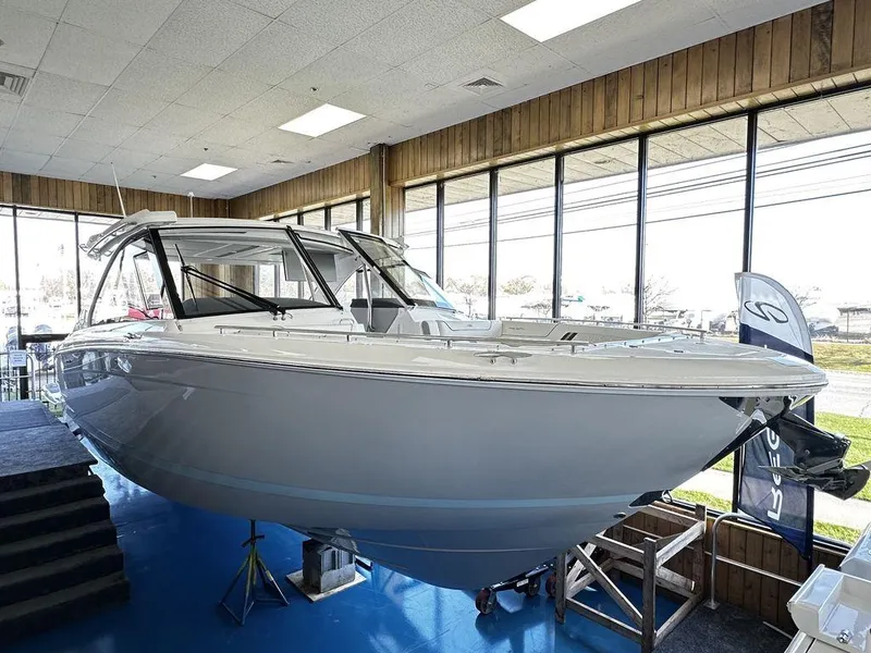 Slide: The Image of 2024 Regal LS36 boat displayed indoors on a blue floor. - 4