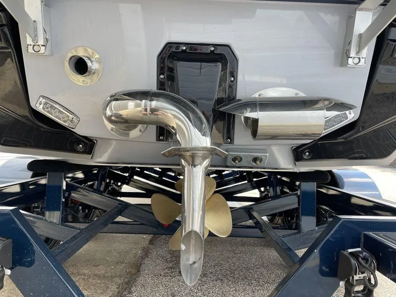 Slide: The Image of 2023 Nautique G25 Paragon boat stern with propeller and exhaust system. - 3