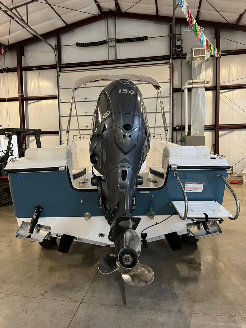 Slide: The Image of 2026 Edgewater 188CC boat in a garage, featuring a powerful outboard motor. - 3