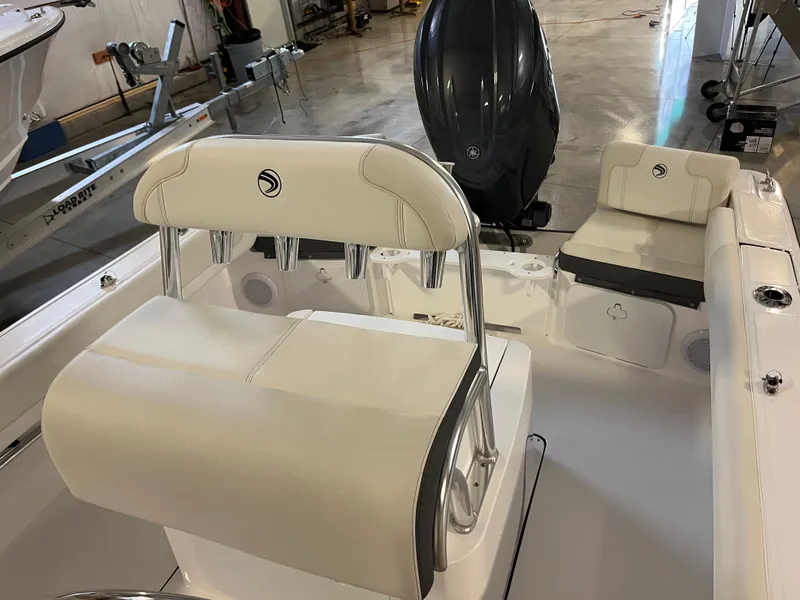 Slide: The Image of 2026 Edgewater 188CC boat interior with seating and motor in a showroom. - 7