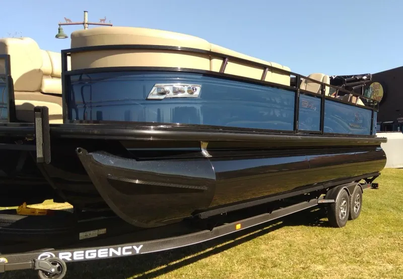 The Image of 2024 Regency 250 DL3 pontoon boat on trailer, side view. - 0