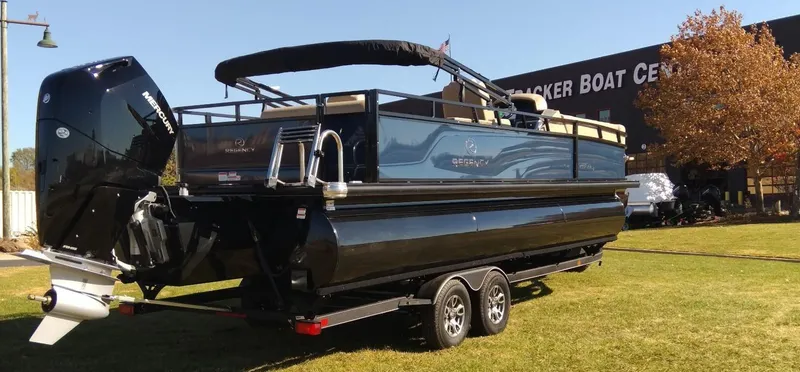 Slide: The Image of 2024 Regency 250 DL3 pontoon boat on a trailer at a boat center. - 3