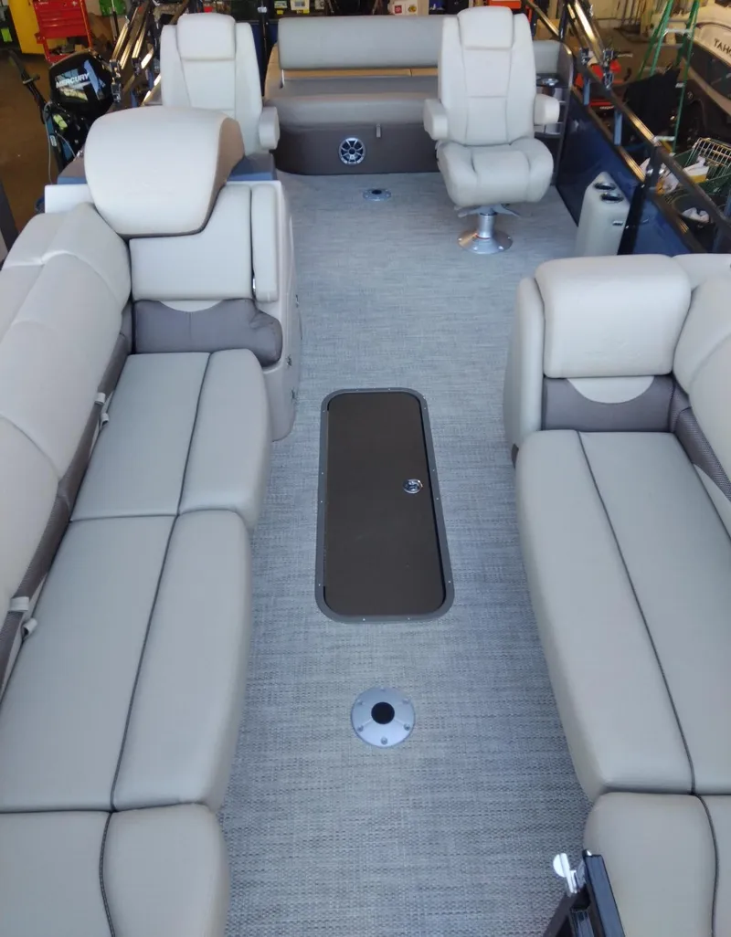 Slide: The Image of 2024 Regency 250 DL3 pontoon boat interior with beige seating. - 4