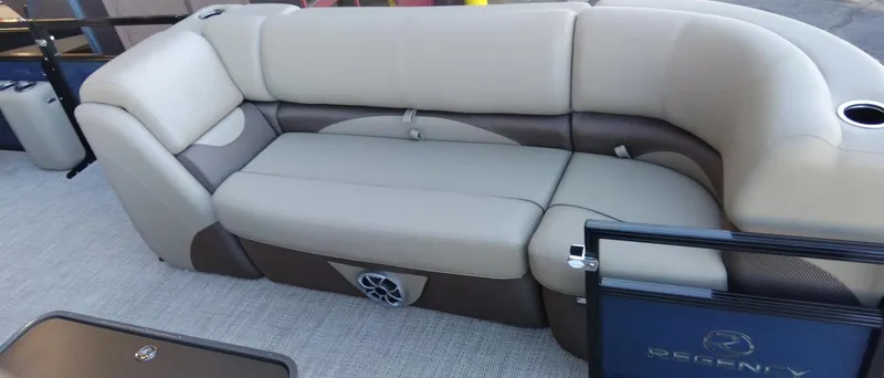Slide: The Image of 2024 Regency 250 DL3 pontoon boat with beige and brown cushioned seating. - 5