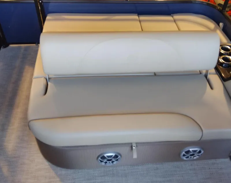 Slide: The Image of 2024 Regency 250 DL3 boat interior seating with built-in speakers and cup holders. - 7