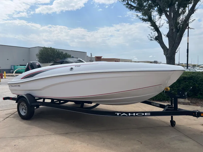 The Image of 2024 Tahoe T18 boat on trailer, parked outdoors. - 0