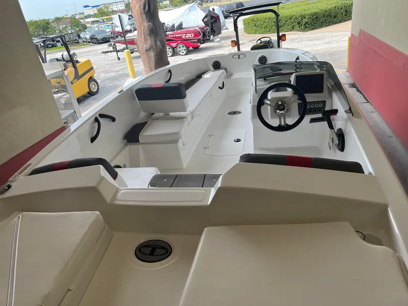 Slide: The Image of 2024 Tahoe T18 boat interior with steering wheel and seating. - 2