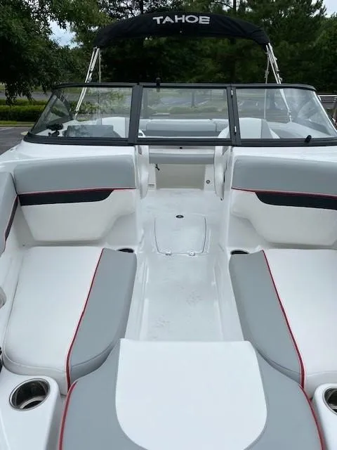 Slide: The Image of 2024 Tahoe 210 Si boat interior with white and gray seating, black canopy. - 2