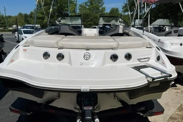Slide: The Image of 2024 Tahoe 210 Si boat, rear view, showcasing sleek design and seating area. - 5