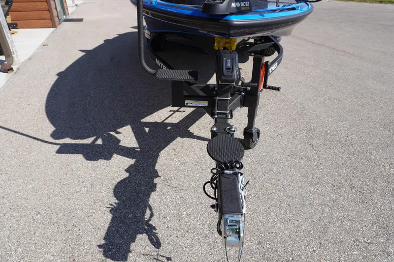 Slide: The Image of 2024 Nitro Z19 boat trailer hitch on pavement, featuring Minn Kota trolling motor. - 47